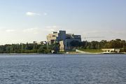 High Court of Australia building and International Flag Display viewed across Lake Burley Griffin from Commonwealth Park